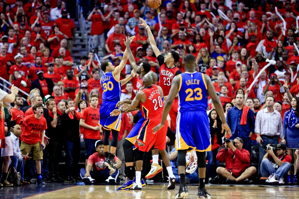 Apr 23, 2015; New Orleans, LA, USA; Golden State Warriors guard Stephen Curry (30) scores on a three point basket over New Orleans Pelicans guard Tyreke Evans (1) and forward Anthony Davis (23) and guard Quincy Pondexter (20) during the final seconds of the fourth quarter sending the game into overtime in game three of the first round of the NBA Playoffs at the Smoothie King Center. The Warriors defeated the Pelicans 123-119 in overtime. Mandatory Credit: Derick E. Hingle-USA TODAY Sports
