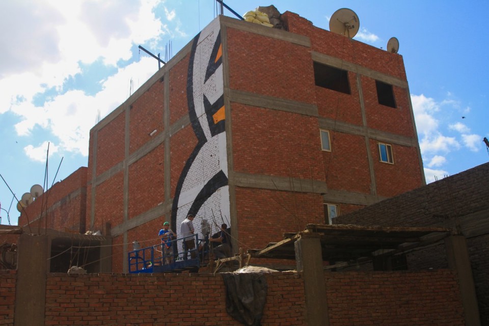 armed-with-small-scaffolding-rigs-and-many-many-cans-of-spray-paint-the-team-set-to-work-on-turning-the-intricate-illustration-into-a-mammoth-work-of-art