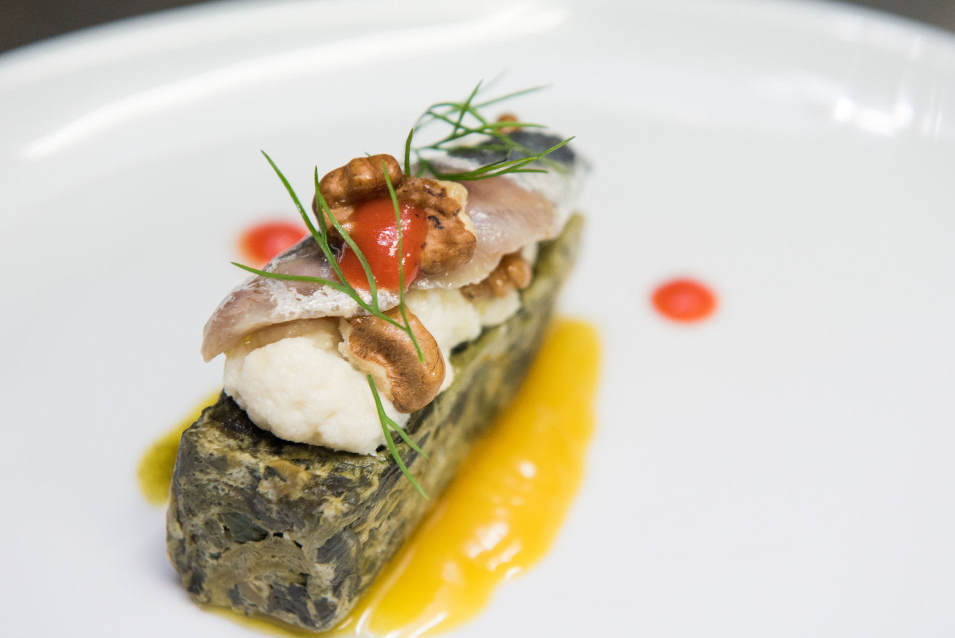 Pomo d' Oro Φλάν σπανάκι με μούς μπακαλιάρου, μαριναρισμένη σαρδέλα, καρύδια και σος πορτοκάλι