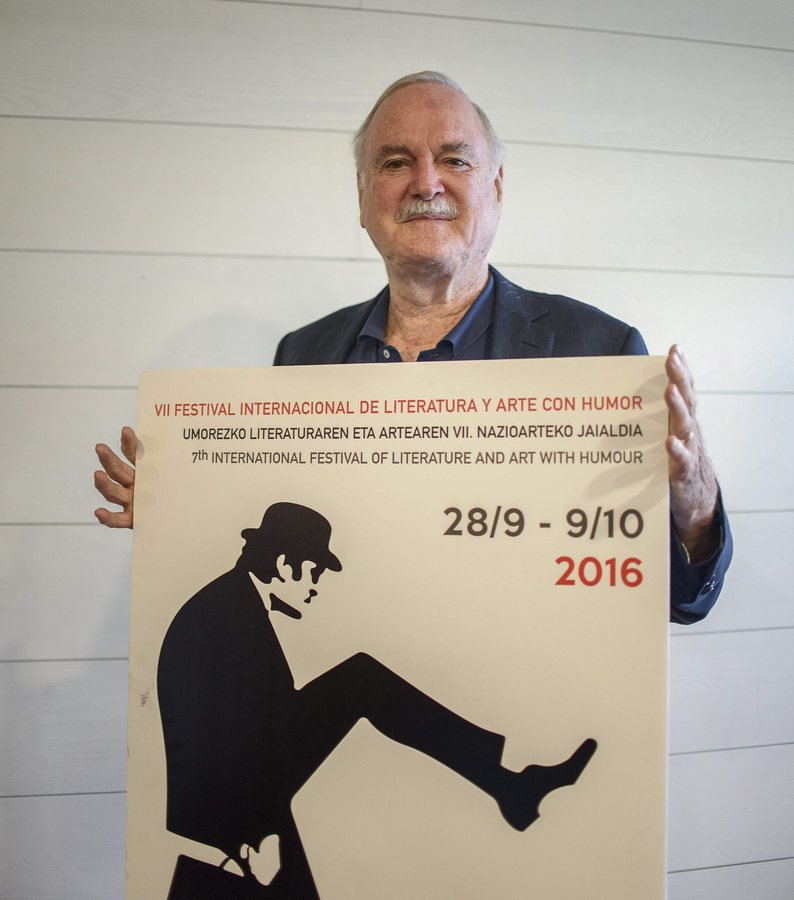 epa05574466 British actor and member of the comedy group Monty Phyton, John Cleese, poses with the poster of the 7th International Festival of Literature and Art with Humor in Bilbao, northern Spain, 07 October 2016. The festival will honour John Cleese this evening in recognition to his career dedicated to humor.  EPA/JAVIER ZORRILLA