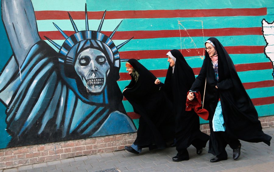 epa05615578 Iranian female students walk next to an anti-US mural on their way to the former US embassy in Tehran to attend a demonstration marking the 37th anniversary of US Embassy takeover in front of the former US embassy in Tehran, Iran, 03 November 2016. Thousands of protesters chanting 'Death to America' gathered at the former US embassy in Tehran to mark the 37th anniversary of the start of the Iran hostage crisis. American, Israel and Saudi Arabia flags were trodden on and burned by participants, who take to the streets every year on 03 or 04 November in a so-called 'day of national confrontation against world imperialism'.  EPA/ABEDIN TAHERKENAREH