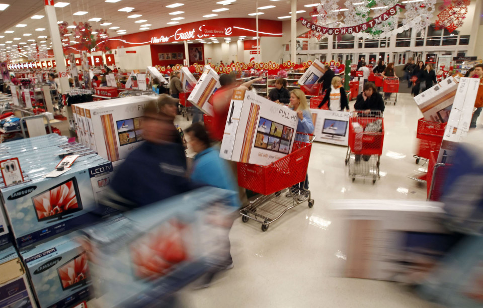 Shoppers grab televisions at the Target in Knoxville, Tenn., minutes after it opened on Friday, Nov. 25, 2011. Shoppers flocked to stores at midnight, hoping to score deep discounts on everything from appliances and televisions to toys and clothes on Black Friday. (AP Photo/The News Sentinel, Wade Payne)