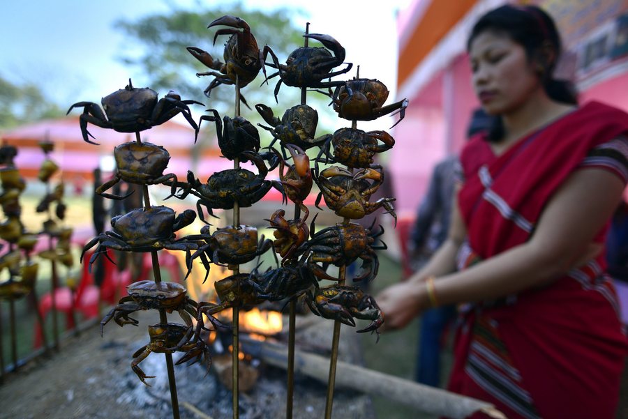 epaselect epa05768829 Smoked crabs and pork are put on display for sale during the Sagrasal festival in Kamrup district of Assam state, India, 03 February 2017. During this festival the young Tiwa boys and girls dance to enrich the fertility power of the earth. They also worship their deities by sacrificing chickens and pray for the good health of their crops. Tiwa is a major tribe of Assam state who practice Jhum or shifting cultivation for their living in the hills.  EPA/STR
