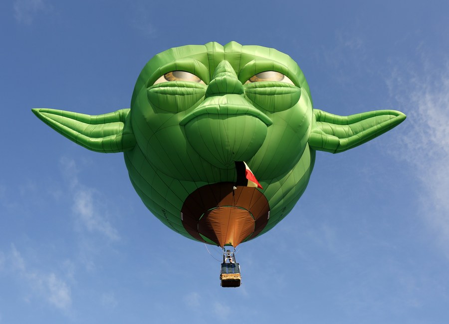 epaselect epa05779366 Crew with their Star Wars character Yoda shaped balloon take off at the start of the four-day 21st Hot Air Balloon festival at the former US Air Force base at Clark, Angeles city, Pampanga province, Philippines, 09 February 2017. The Hot Air Balloon Festival kicked off with 29 participating teams, as part of efforts in tourism and aviation sports promotion in the Philippines.  EPA/FRANCIS R. MALASIG