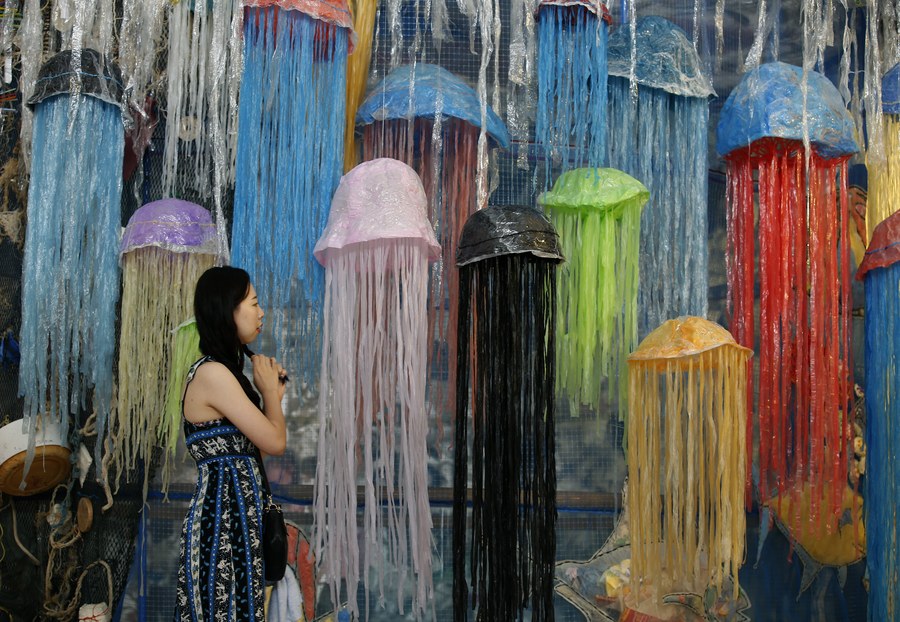 epa05794473 A visitor walks past an art installation on display during the 'Heart for the Ocean : Break Free from Plastic' exhibition at Bangkok Art and Culture Centre in Bangkok, Thailand, 15 February 2017. The exhibition was created and made of plastic and garbage from the city and five local beaches in Thailand, to raise awareness on the environmental impacts of plastics to the marine environment. The exhibition is held until 19 February 2017.  EPA/NARONG SANGNAK