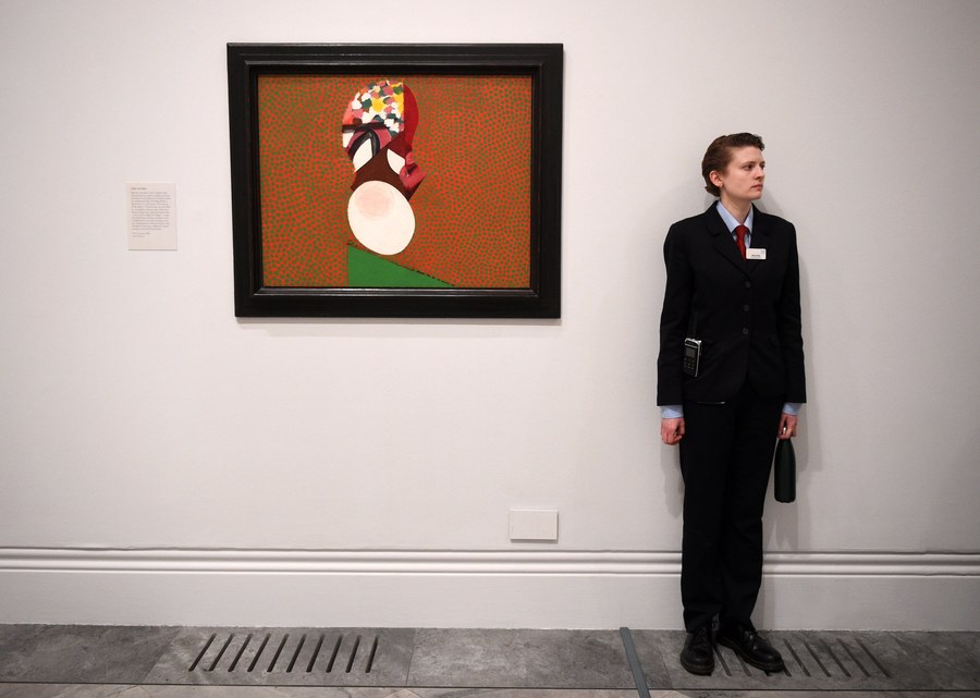 epa05863452 A gallery employee stands next to a painting entitled 'Girl in Bed' by British artist Howard Hodgkin during the press preview of the exhibition 'Absent Friends' at the National Portrait Gallery in London, Britain, 22 March 2017. The exhibition dedicated to Hodgkin (1932-2017) opens to the public from 23 March to 18 June.  EPA/FACUNDO ARRIZABALAGA
