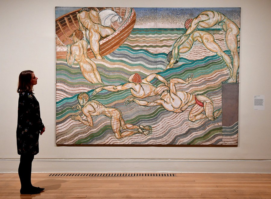 epa05885737 A Tate Britain staff looks over a painting by Duncan Grant titled 'Bathing' (1911) during Tate Britain's 'Queer British Art' exhibit at the Tate Britain in London, Britain, 03 April 2017. Tate Britain is opening its first exhibition dedicated to queer British art unveiling material that relates to gay, lesbian, bisexual, trans and queer identities. The show marks fifty years partial decriminalisation of male homosexuality in England and Wales.  EPA/ANDY RAIN